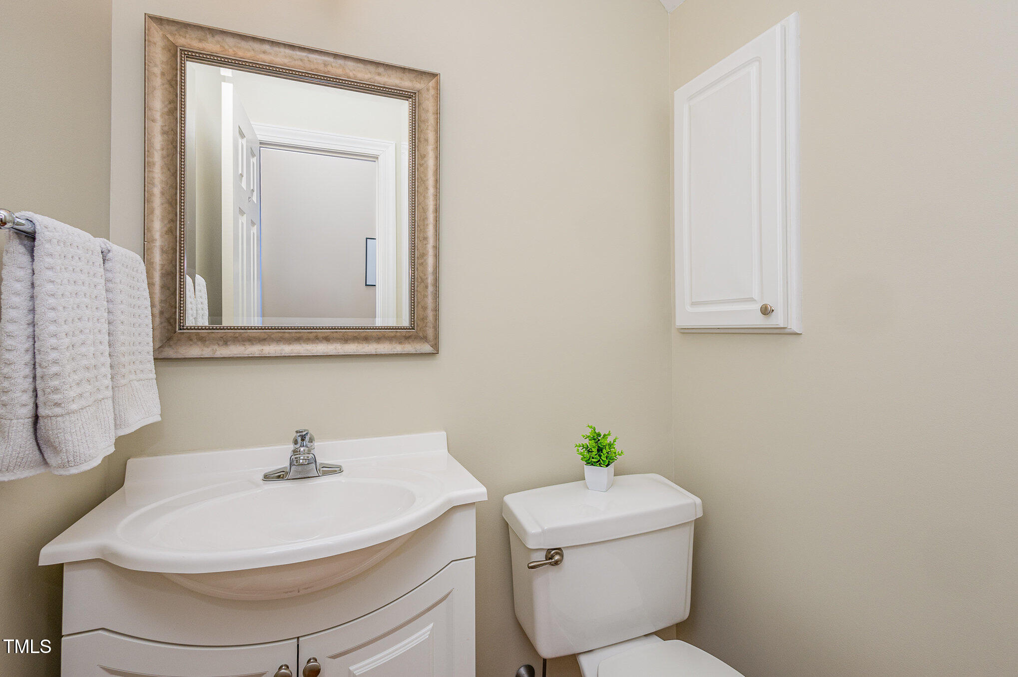 2719 Amstel Way Raleigh, NC 27613 - Photo 12 of 41 a bathroom with a sink a toilet and mirror