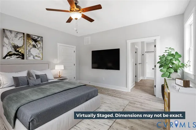 a living room with a couch and a potted plant