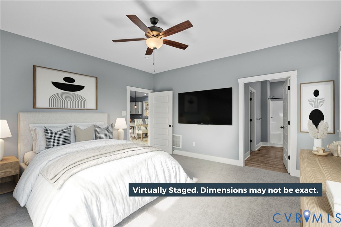 2794 South Constitution Route Dillwyn, VA 23936 - Photo 19 of 22 a living room with a bed a flat screen tv and a ceiling fan
