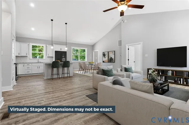 a living room with furniture wooden floor and a flat screen tv
