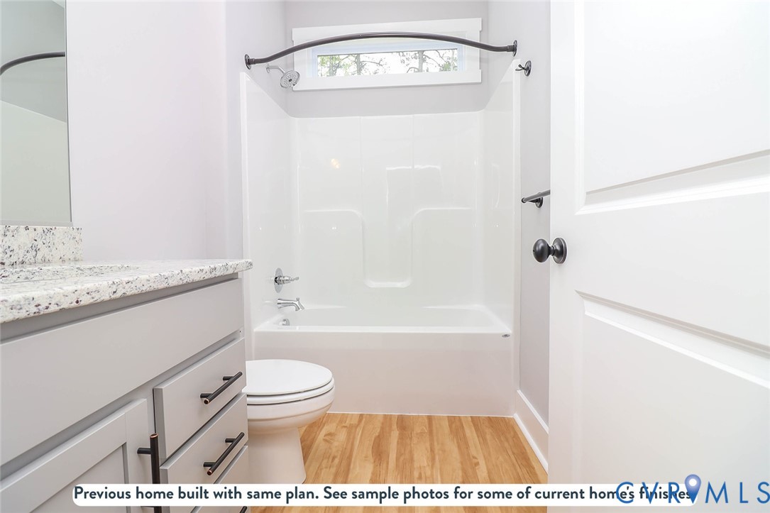 2794 South Constitution Route Dillwyn, VA 23936 - Photo 6 of 22 a bathroom with a granite countertop sink a toilet and bathtub