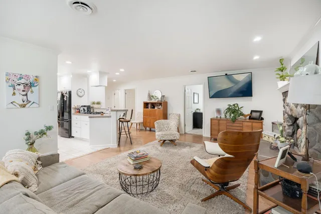 a large kitchen with stainless steel appliances a sink a stove and cabinets