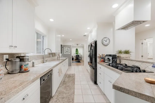 a bedroom with bed and a chandelier