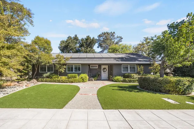 a view of house with outdoor space and swimming pool