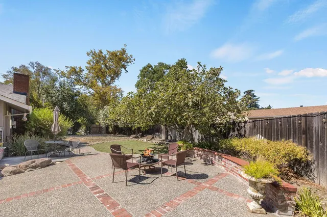 an aerial view of a house with a yard and trees