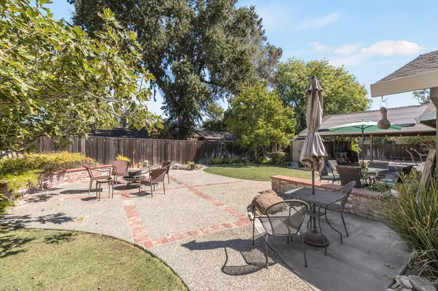 a view of a house with a yard covered in snow