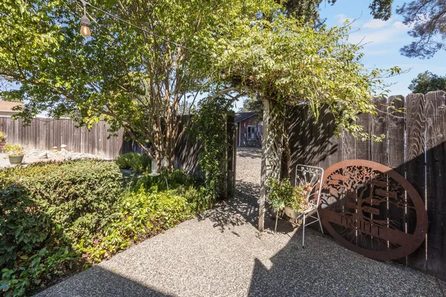 a view of a patio with table and chairs and potted plants