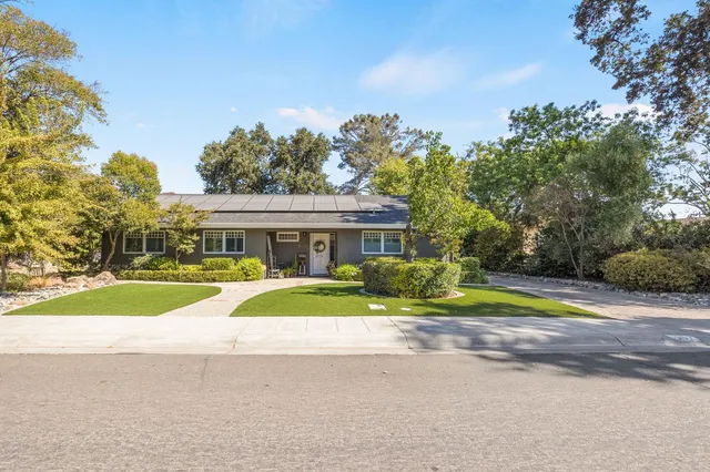 a view of house with outdoor space and swimming pool