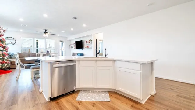 a view of a workspace with furniture window and wooden floor