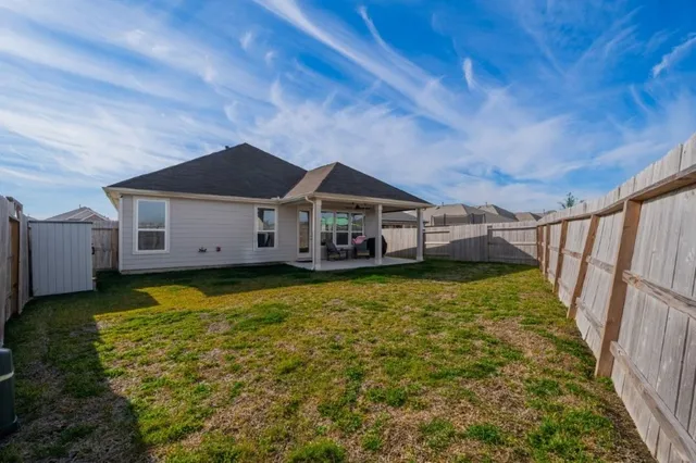 a view of a porch with chairs and backyard