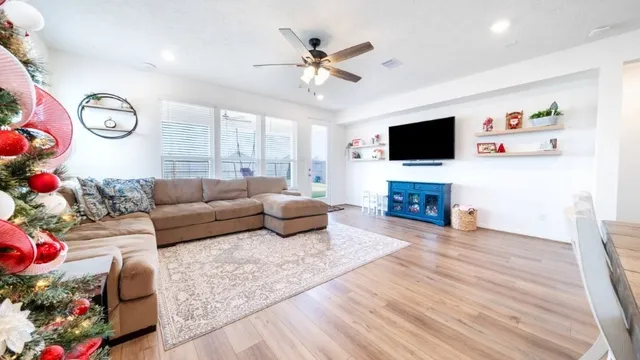 a view of a dining room with furniture and wooden floor