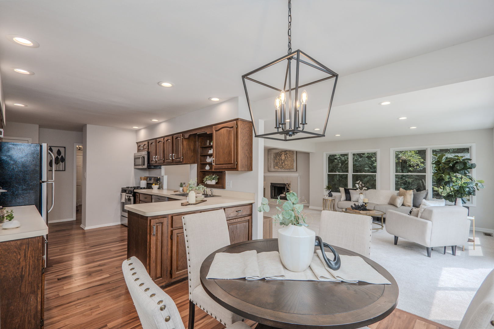 1936 South Street Geneva, IL 60134 - Photo 16 of 41 a living room with furniture a dining table and a chandelier