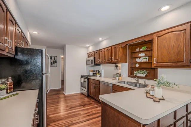 a kitchen with stainless steel appliances granite countertop a sink stove and refrigerator
