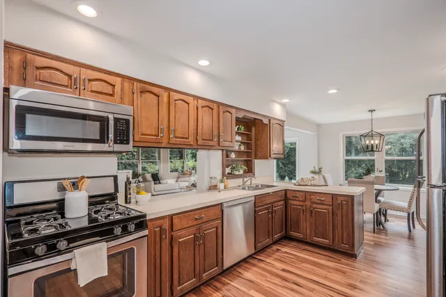 a kitchen with a sink stove and microwave