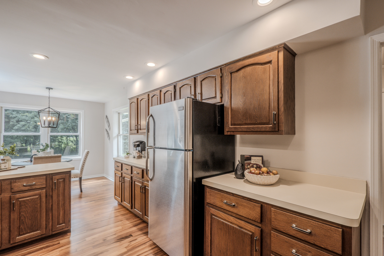 1936 South Street Geneva, IL 60134 - Photo 19 of 41 a kitchen with stainless steel appliances granite countertop a refrigerator a sink dishwasher and wooden cabinets with wooden floor