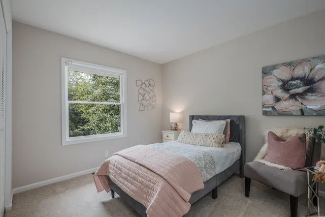 a bedroom with a bed and window