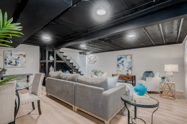 a living room with furniture and a chandelier
