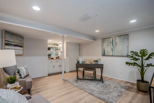 a living room with furniture and potted plant