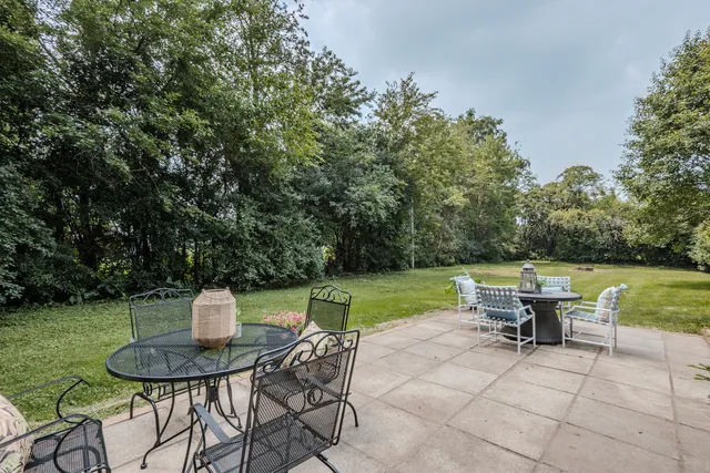 a view of a table and chairs in the garden