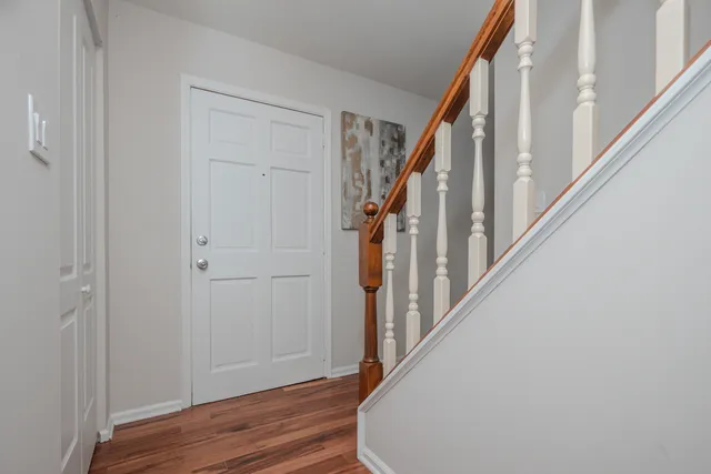 a view of an entryway with wooden floor