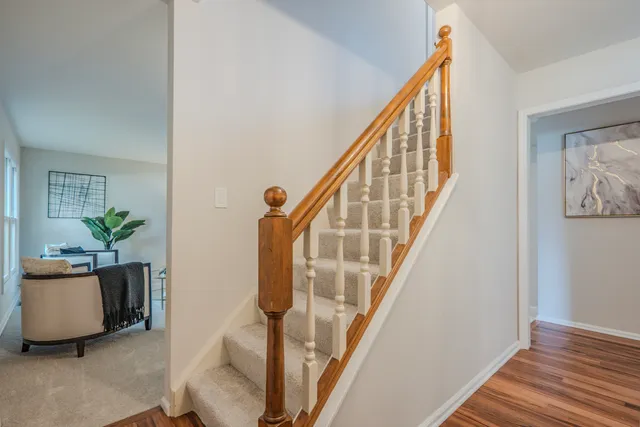 a view of an entryway with wooden floor and stairs