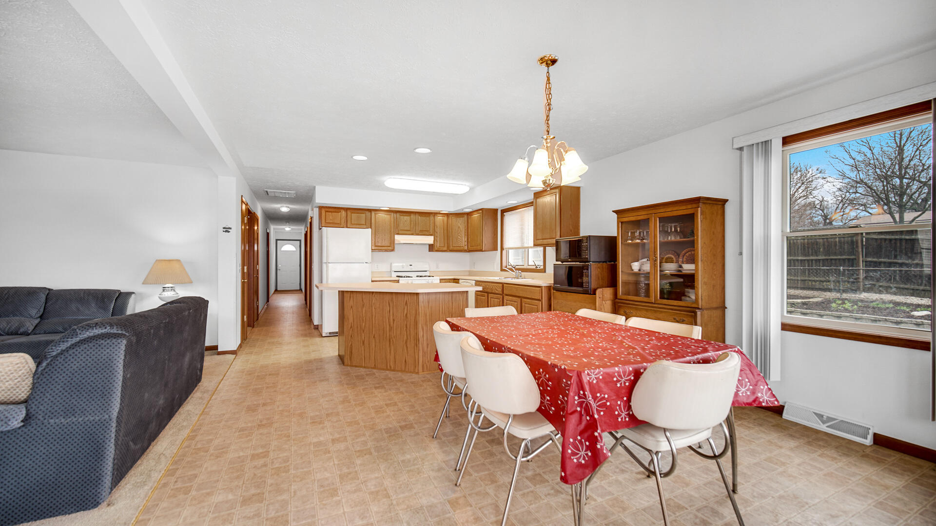 4472 South County Road 210 Knox, IN 46534 - Photo 11 of 30 a view of a dining room and livingroom with furniture wooden floor a chandelier