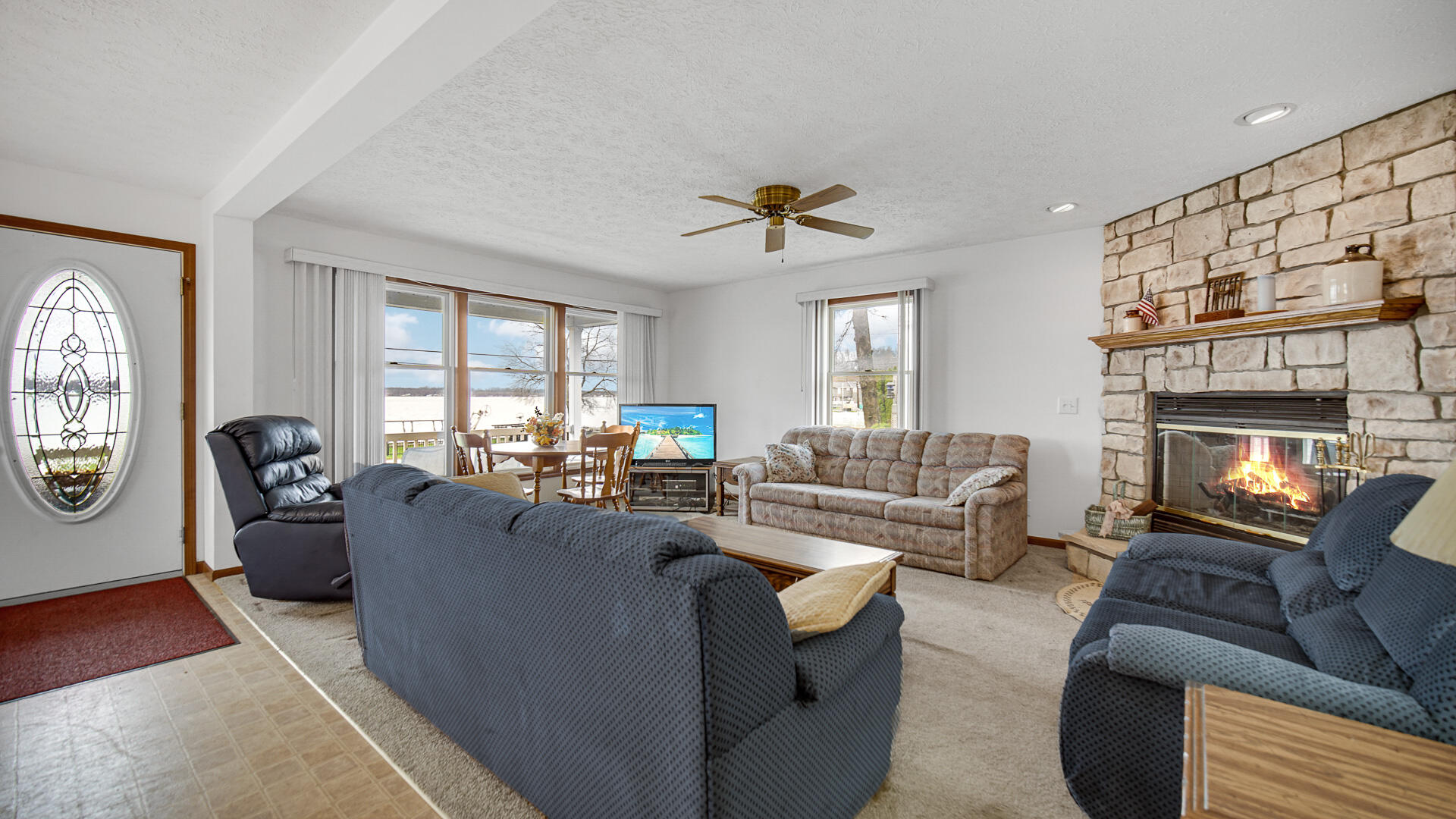 4472 South County Road 210 Knox, IN 46534 - Photo 15 of 30 a living room with fireplace furniture and a large window