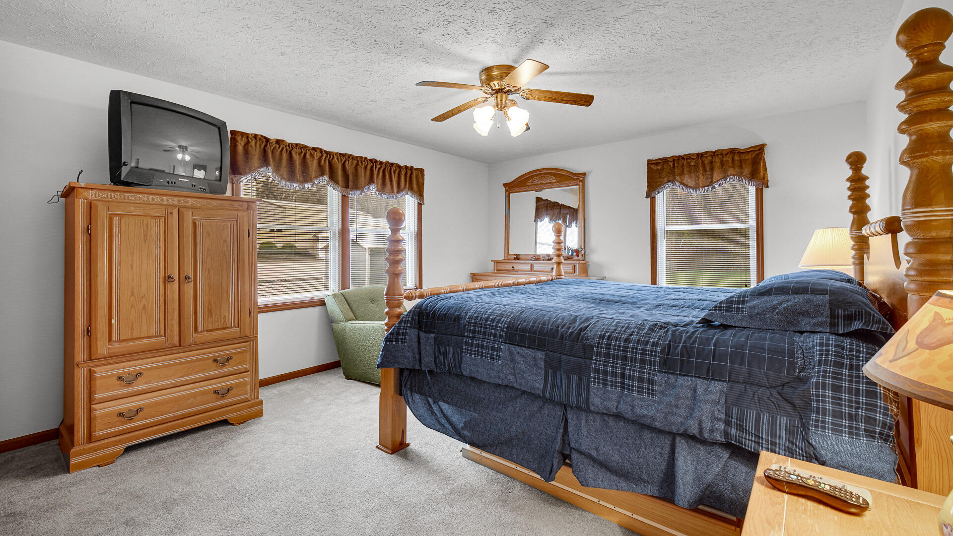 4472 South County Road 210 Knox, IN 46534 - Photo 18 of 30 a bedroom with a bed and a chandelier