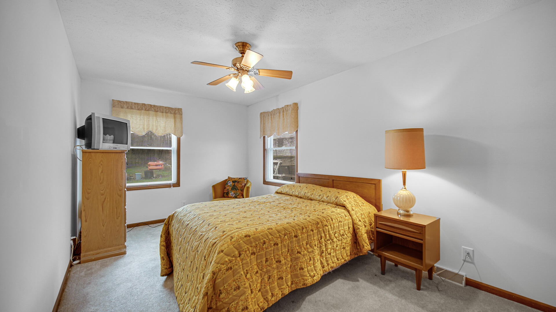 4472 South County Road 210 Knox, IN 46534 - Photo 20 of 30 a bedroom with a bed and a chandelier