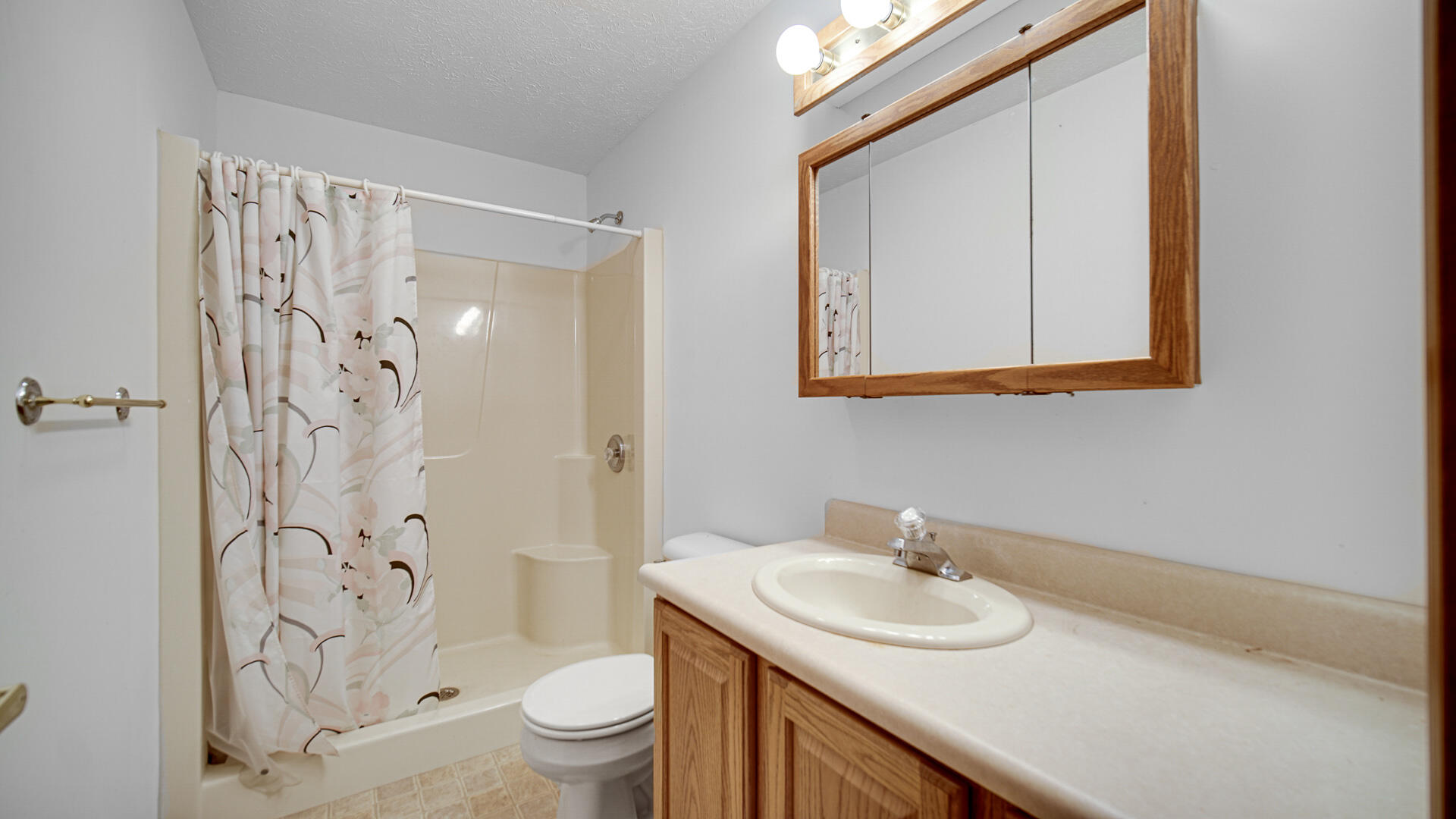 4472 South County Road 210 Knox, IN 46534 - Photo 22 of 30 a bathroom with a sink toilet and shower