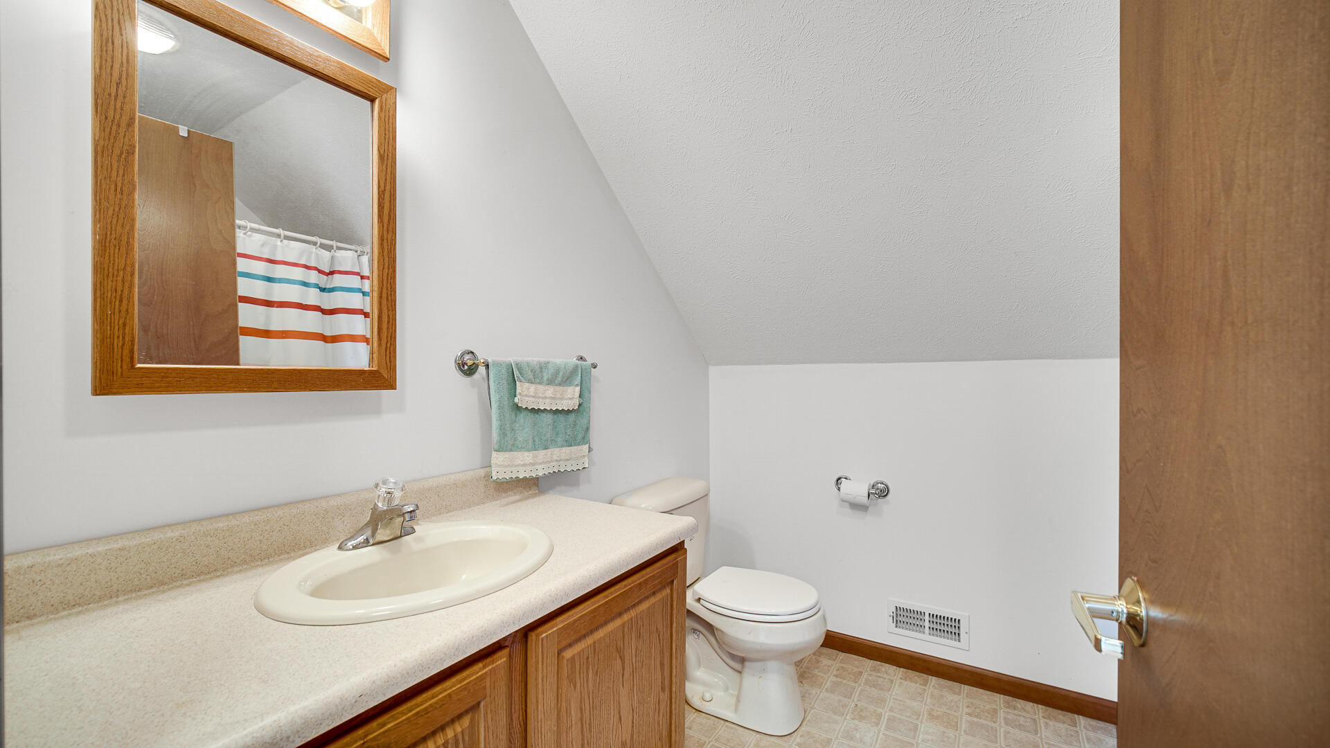 4472 South County Road 210 Knox, IN 46534 - Photo 26 of 30 a bathroom with a sink vanity mirror and toilet