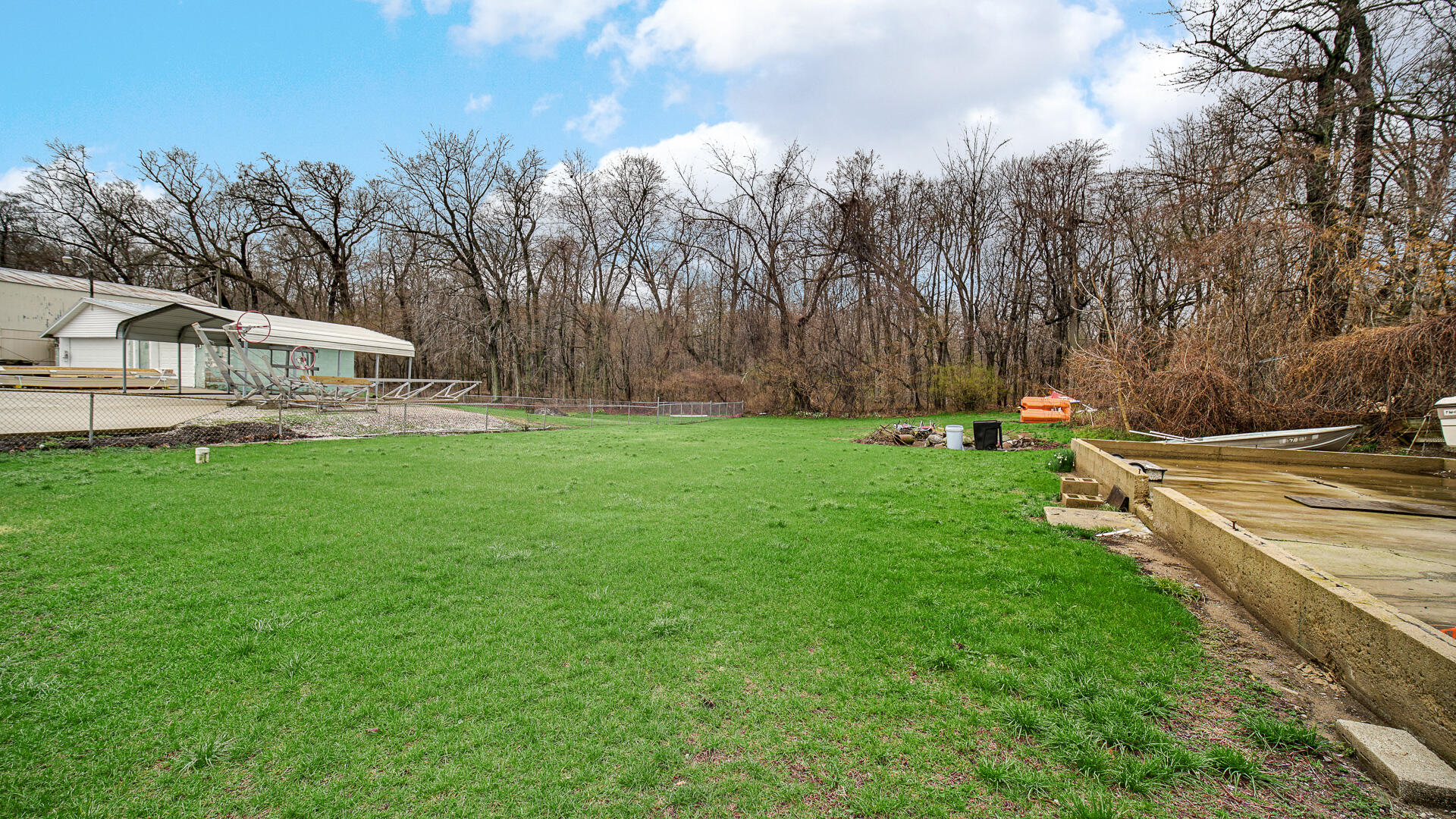 4472 South County Road 210 Knox, IN 46534 - Photo 28 of 30 a view of a house with a big yard and potted plants