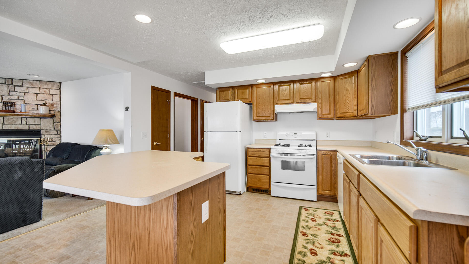 4472 South County Road 210 Knox, IN 46534 - Photo 10 of 30 a kitchen with a stove a sink and a refrigerator
