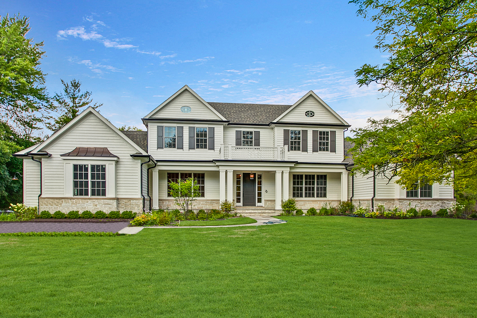 152 North Ridge Road Lake Forest, IL 60045 - Photo 1 of 23 a front view of a house with a garden and trees