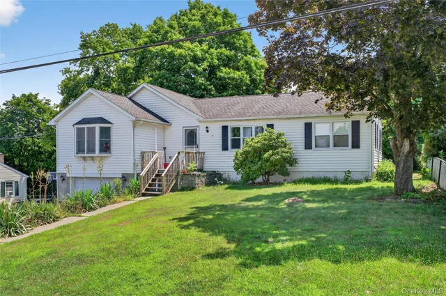 a view of backyard of house with green space