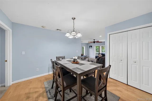 a view of a dining room with a table and chairs