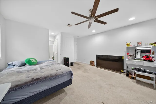 a bedroom with furniture and a ceiling fan