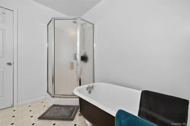 a bathroom with a tub and shower