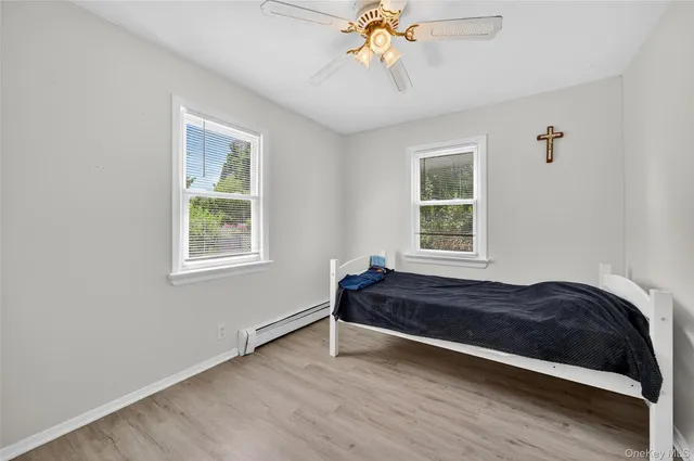 a spacious bedroom with a bed and a window