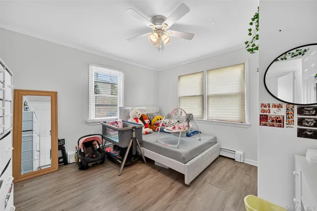 a bedroom with furniture and a large window