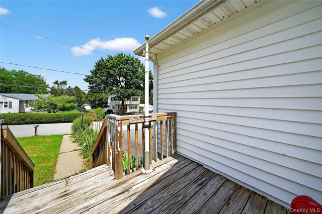 a view of a chair and table in the back yard of a house