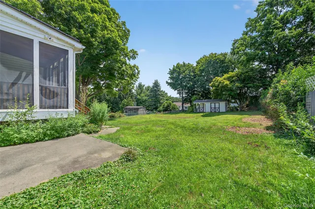 a view of a house with a yard and a garden