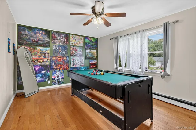 a room with musical instrument pool table and windows