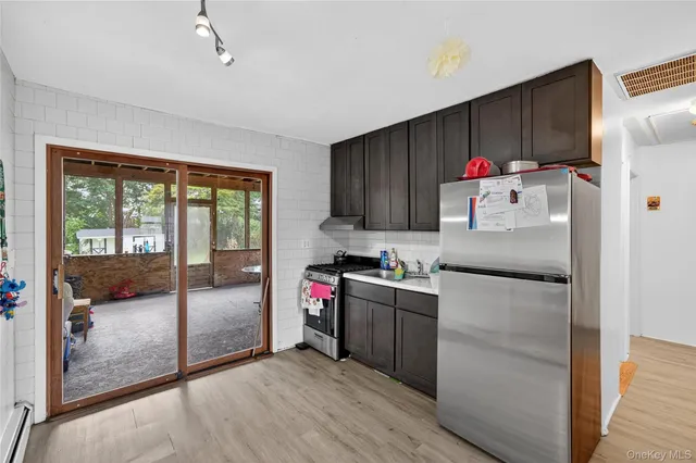 a kitchen with granite countertop a refrigerator and a sink