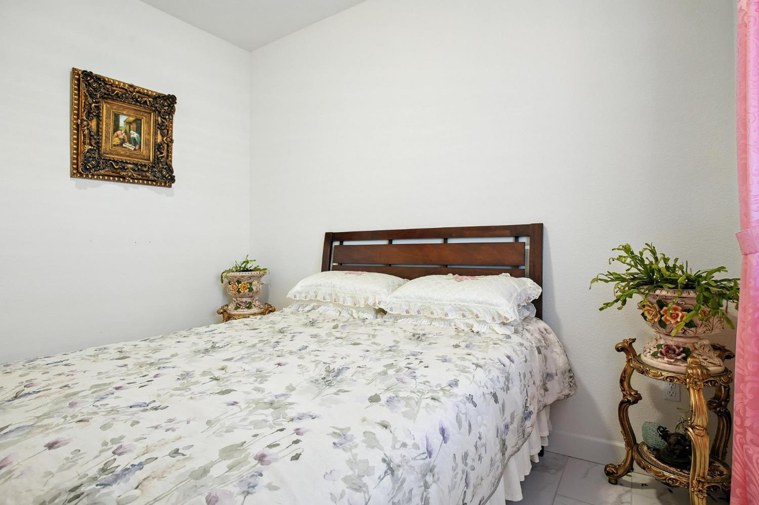 3742 Haymaker Way Sacramento, CA 95835 - Photo 16 of 39 a bedroom with a bed and a potted plant