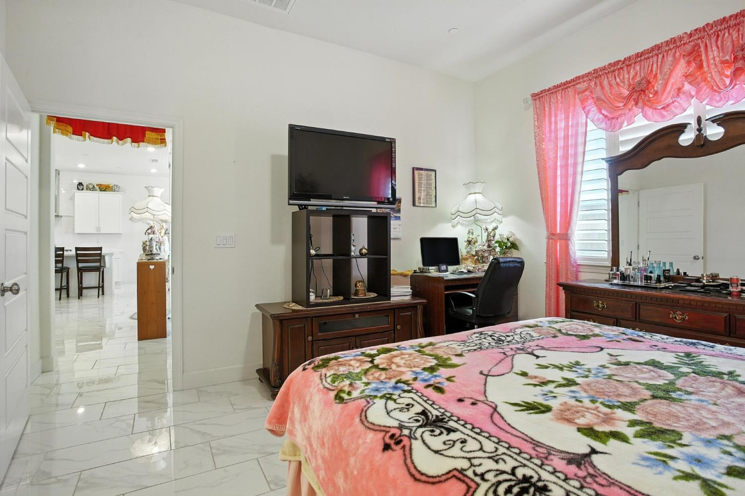 3742 Haymaker Way Sacramento, CA 95835 - Photo 22 of 39 a bedroom with a bed and a mirror on dresser