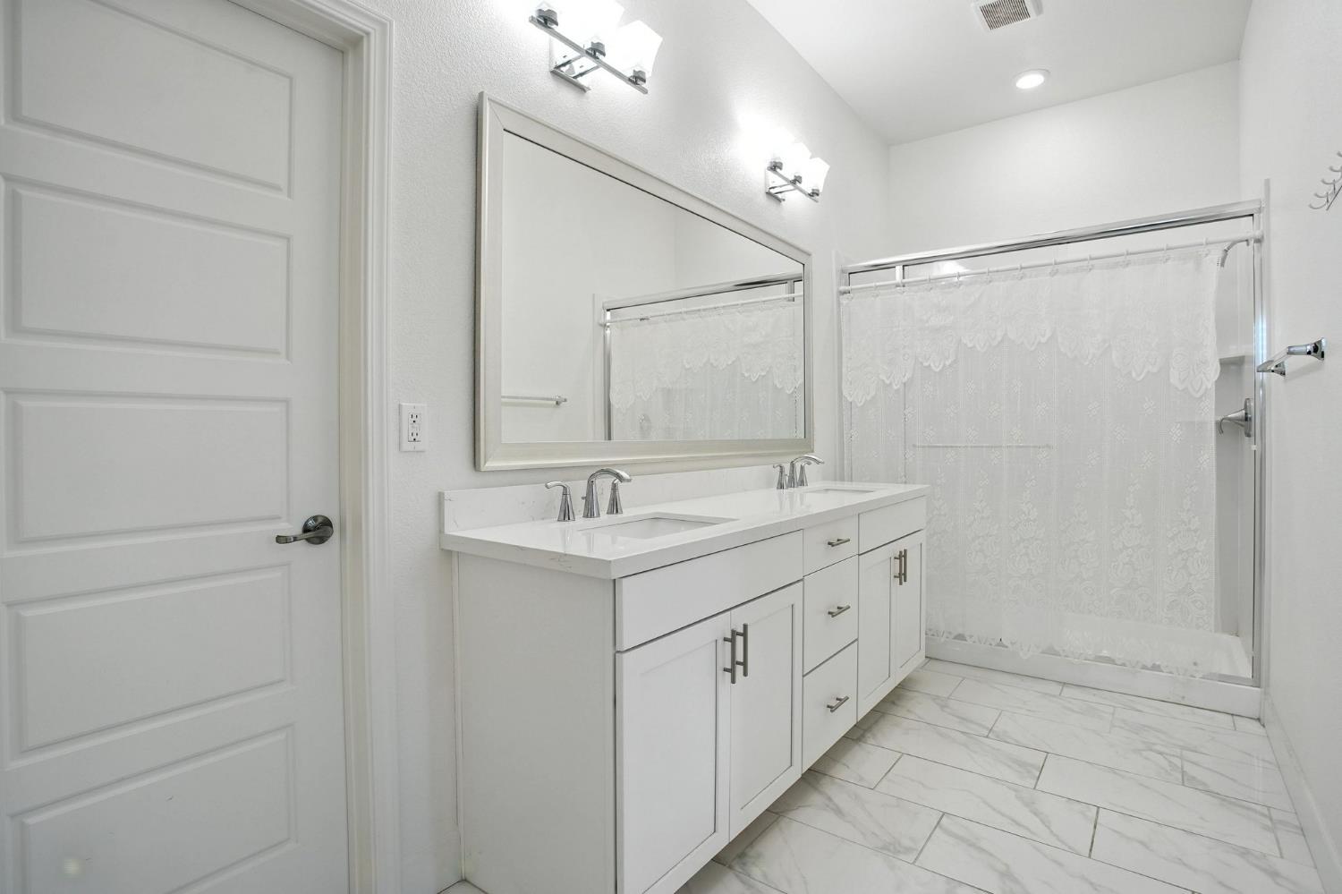 3742 Haymaker Way Sacramento, CA 95835 - Photo 25 of 39 a bathroom with a double vanity sink and a mirror