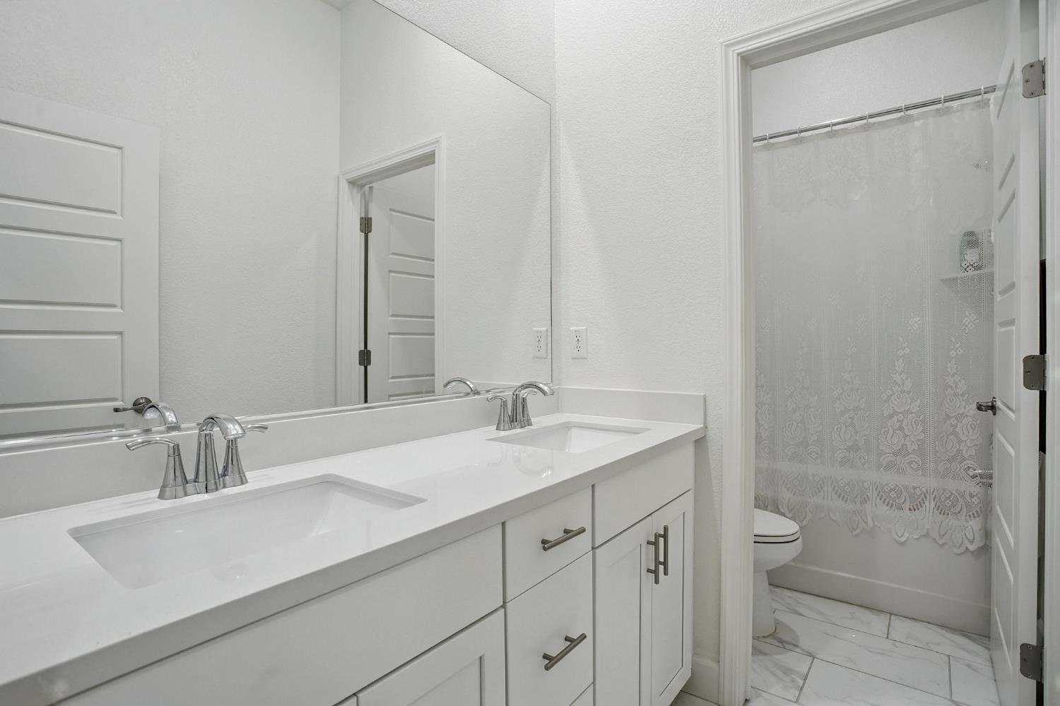 3742 Haymaker Way Sacramento, CA 95835 - Photo 27 of 39 a bathroom with a sink and a mirror