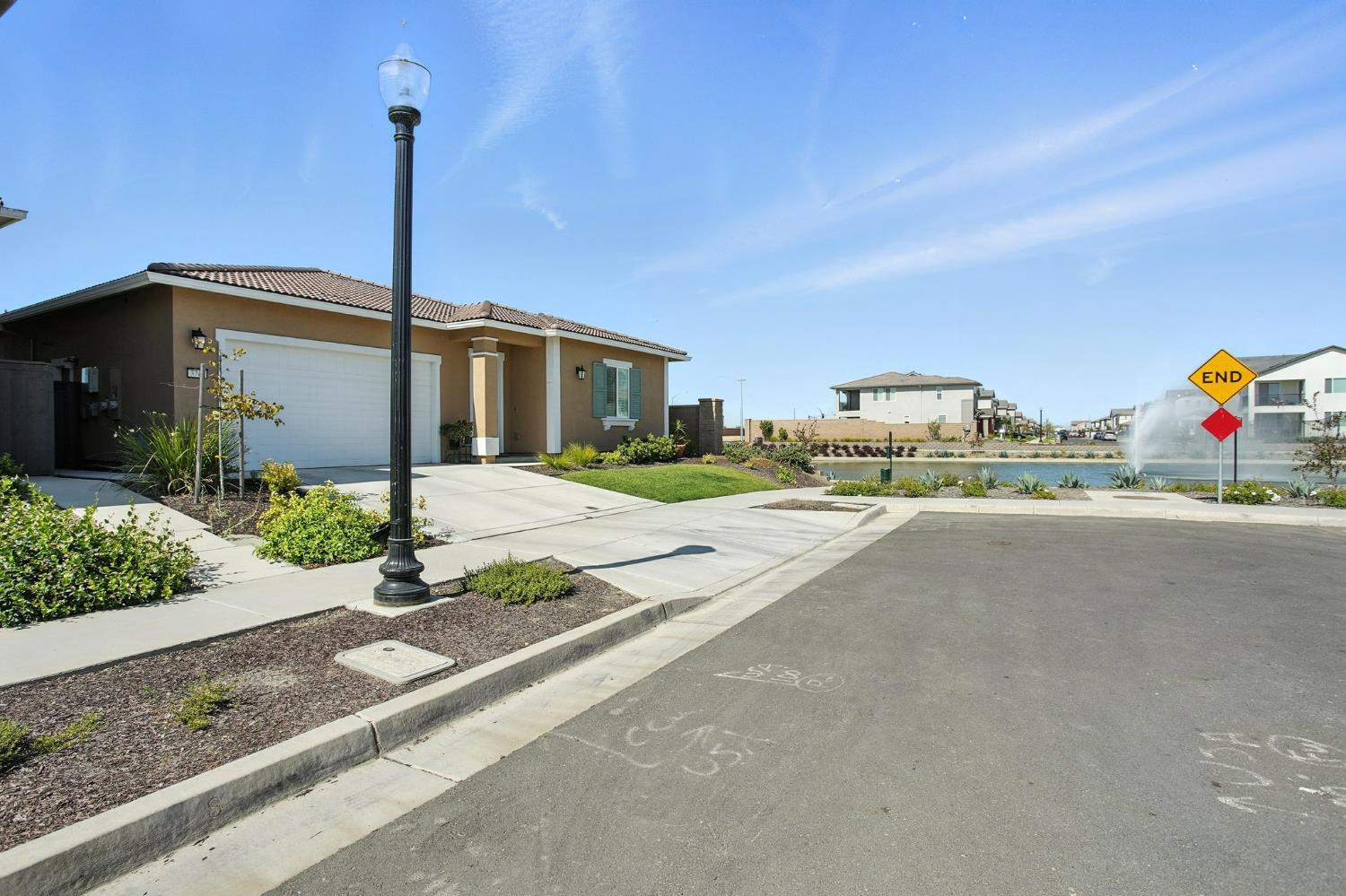 3742 Haymaker Way Sacramento, CA 95835 - Photo 3 of 39 a front view of a building with garden and plants