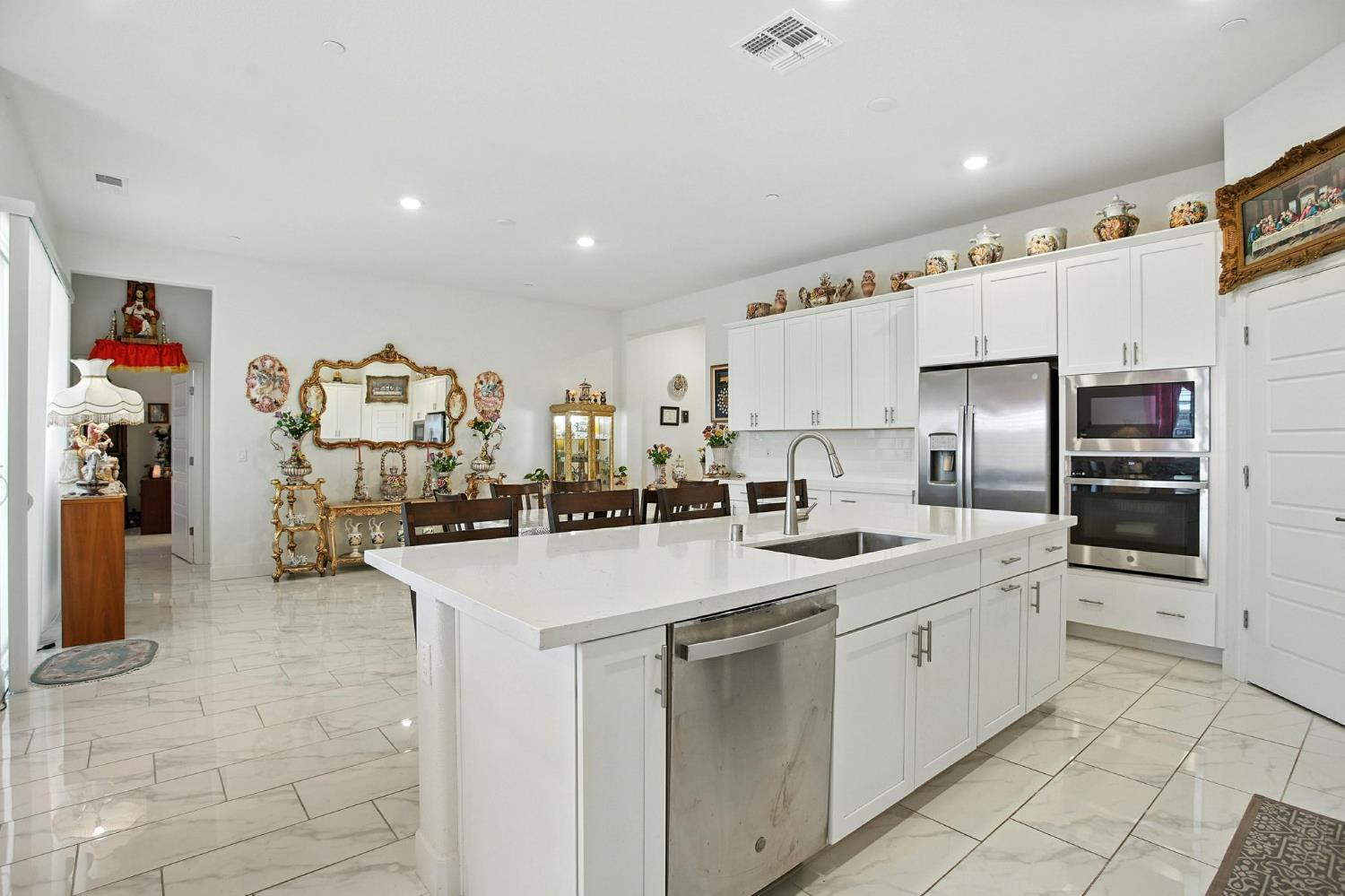3742 Haymaker Way Sacramento, CA 95835 - Photo 9 of 39 a kitchen with stainless steel appliances a sink a stove a refrigerator and cabinets
